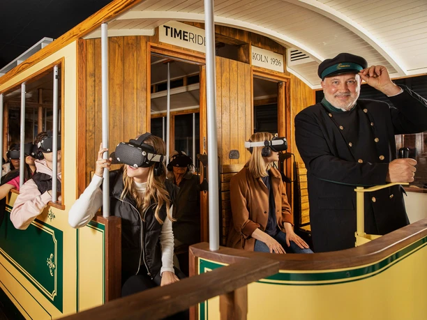 Timeride SENSEUM People in a historic streetcar wear VR glasses and experience a virtual journey through time.