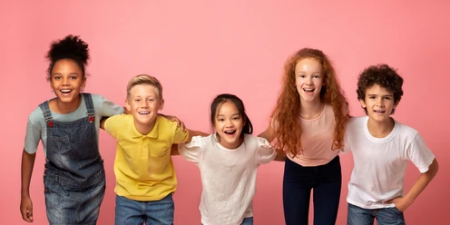 Portrait of multiethnic schoolkids smiling on pink background Portrait of multiethnic schoolkids smiling on pink background