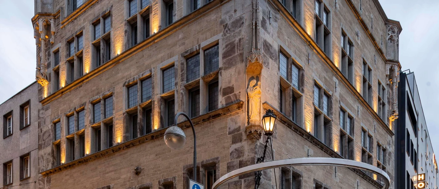 Saaleck House, artothek Historic building with ornate corner towers, multi-storey windows and evening lighting.