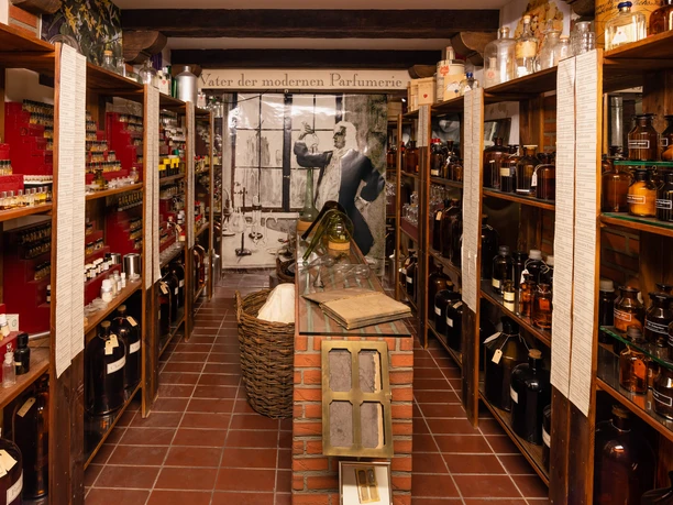 Farina Fragrance Museum In the Farina Fragrance Museum, a historic perfumery is showcased with shelves full of bottles and containers, offering a journey into the history of perfume production.