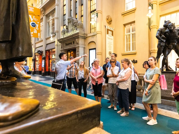 One group discovers the Mädler Passage and Auerbach's cellar on a city tour.