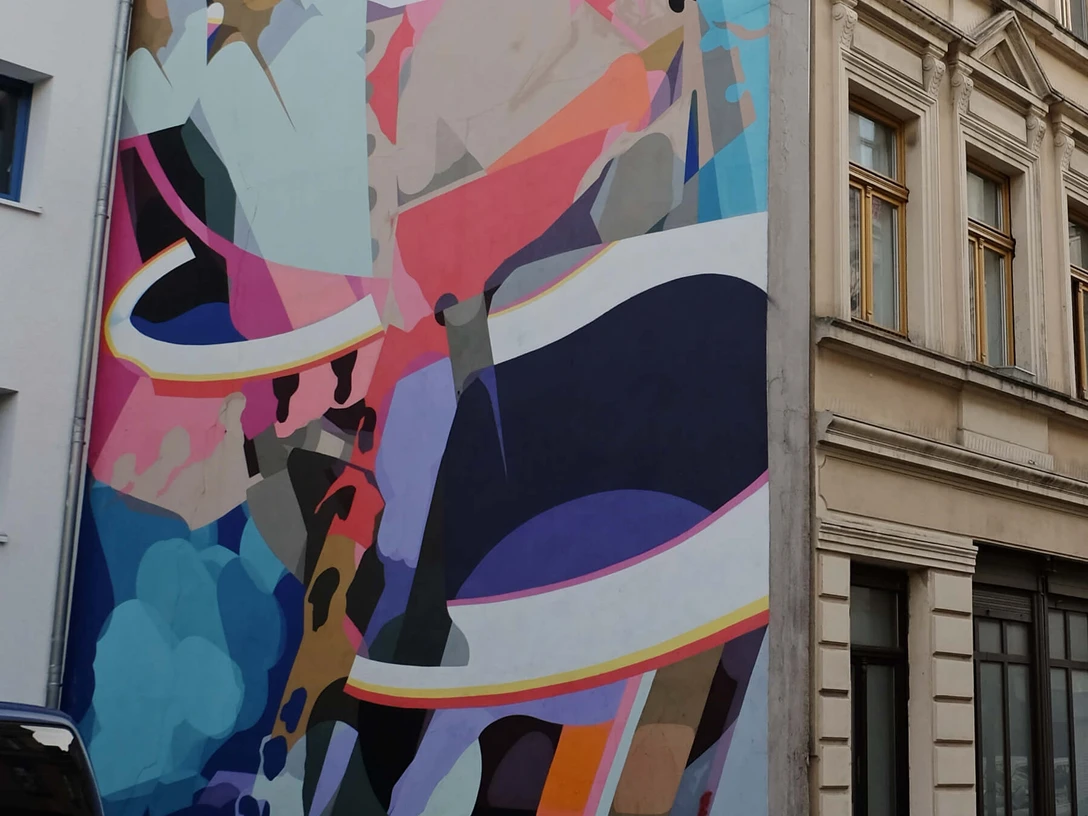 Mural Abstrakte farbenfrohe Graffiti-Kunstwerke bedecken die Fassade eines mehrstöckigen Hauses, Köln.Abstract, colorful graffiti artwork covers the façade of a multi-story building in Cologne.