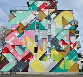 Mural Colorful geometric mural on a high-rise building with bright colors and abstract shapes.