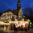 Weihnachtlich beleuchteter Marktplatz in Nienburg mit Karussell und Fachwerkgebäude bei Dämmerung.Christmas-lit market square in Nienburg with carousel and half-timbered building at dusk.Juleoplyst markedsplads i Nienburg med karrusel og bindingsværksbygning i skumringen.Kerstverlicht marktplein in Nienburg met draaimolen en vakwerkgebouw in de schemering.