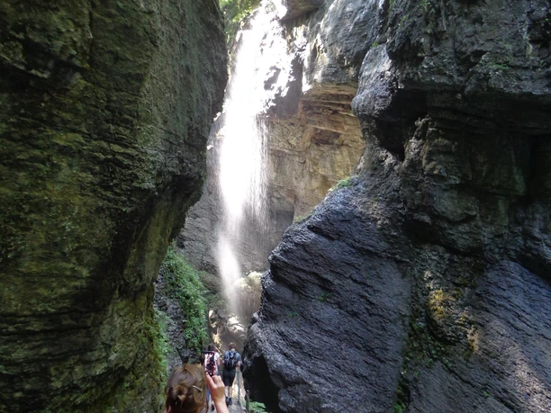 In der Klamm Schmale Klamm mit Wasserfall, Wandernde auf Steg neben türkisfarbenem Bach