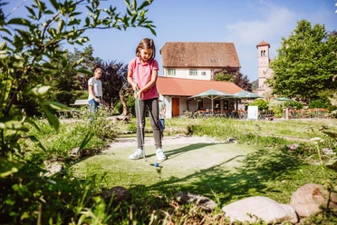 Eine Familie spielt Minigolf in Klosterreichenbach