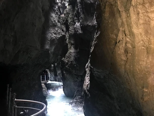 Partnachklamm Enge Felsenschlucht mit türkisfarbenem Wildwasser und schmalem gesichertem Steg.