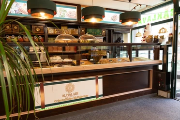 Al Halabi - Oriental sweets in Leipzig You can see a modern counter of the store, which presents a selection of different sweets