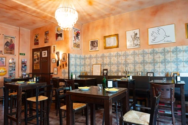 The La Cantina restaurant is furnished in dark wood and the walls are half-tiled.