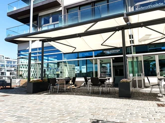 Hafenterrasse (Weitansicht) Terrace with seating and awning