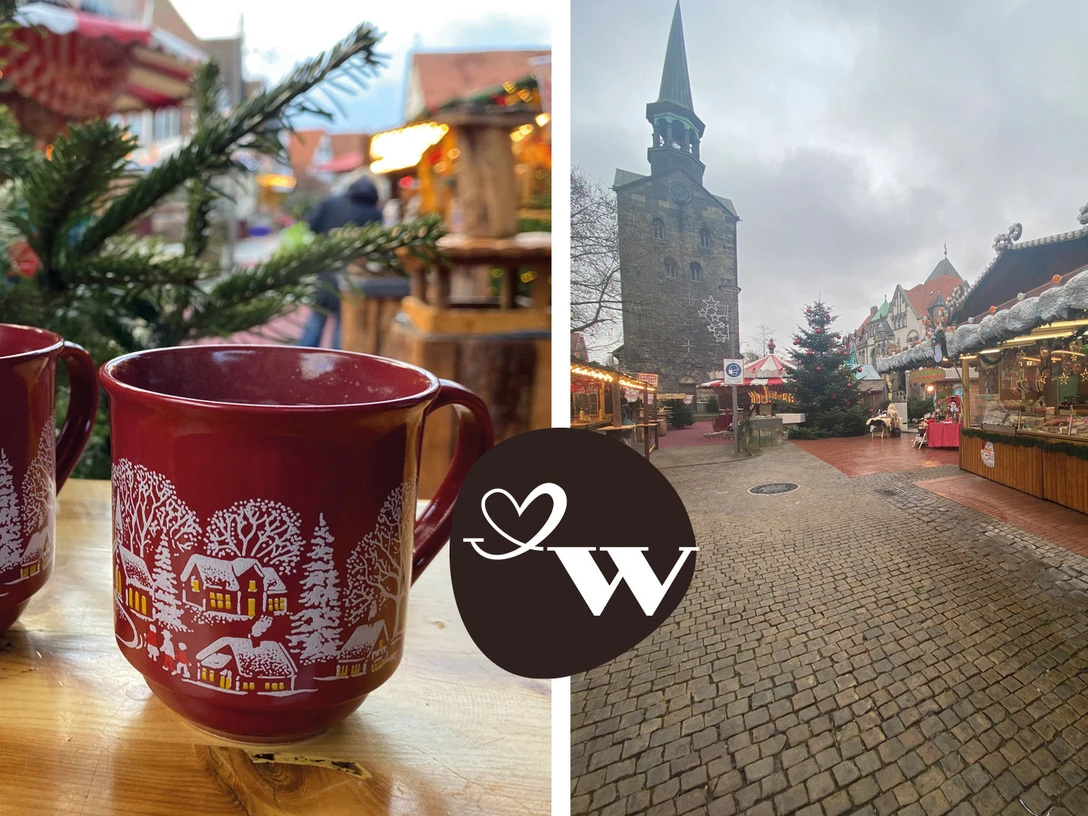 WGW Weihnachtsmarkt Zwei rote Tassen mit winterlichem Motiv auf einem Weihnachtsmarkt vor einer Kirche im Hintergrund.Two red cups with a winter motif at a Christmas market with a church in the background.To røde kopper med vintermotiv på et julemarked med en kirke i baggrunden.Twee rode kopjes met een winters motief op een kerstmarkt met een kerk op de achtergrond.