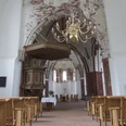 Kirche in Pilsum Kreuzkirche interior, pews, pulpit, golden chandelier on the ceiling