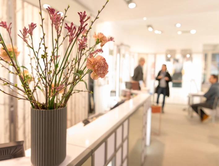 Hanssen by Herr Lutz Innenraum eines Optikergeschäfts mit Blumenstrauß im Vordergrund
