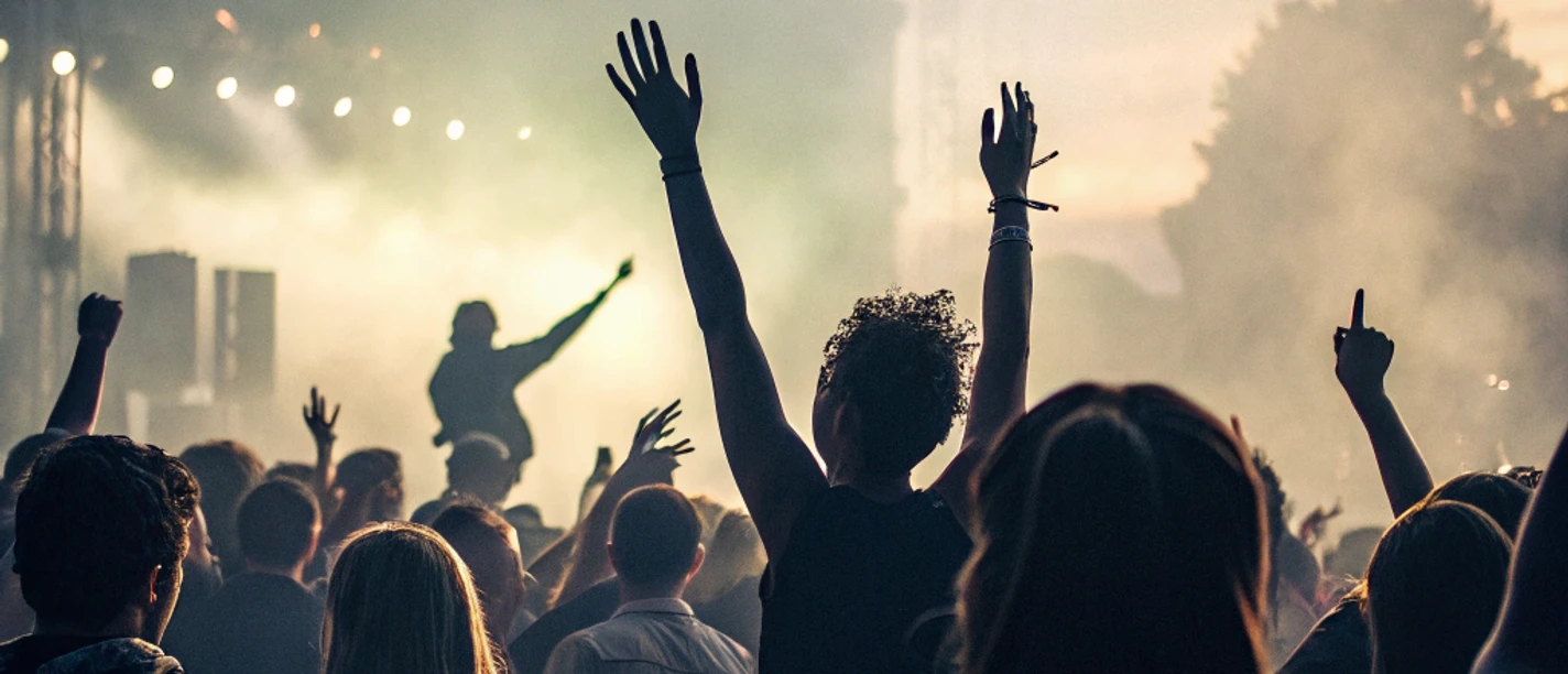 many-people-raising-their-hands-while-dancing-at-a.png
