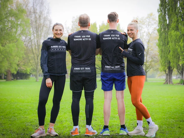 Čtyři lidé z Running City Tours stojí ve sportovním oblečení v parku