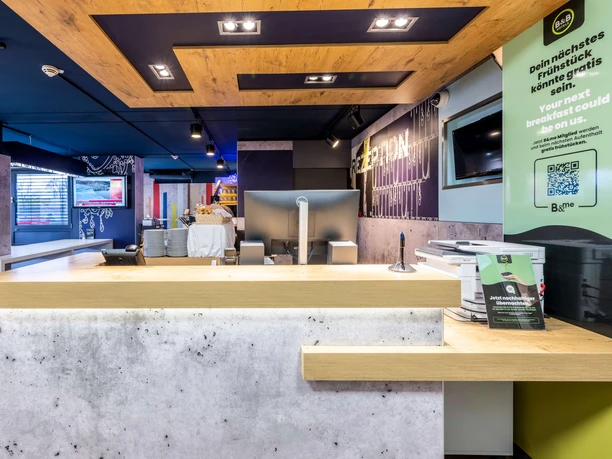 Rezeption im B&B HOTEL Düsseldorf-Hilden Empfangstresen des B&B HOTEL Düsseldorf-Hilden mit modernen Designelementen und heller Beleuchtung.