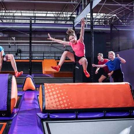 Deux jeunes personnes sautent par-dessus un obstacle au JUMP House Leipzig, loisirs, famille, excursion