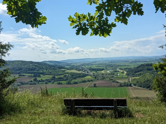 Ausblick vom Altendorfer Berg Holzbank am Waldrand mit weitem Blick über Felder, Wälder und das Leinetal bei Einbeck.