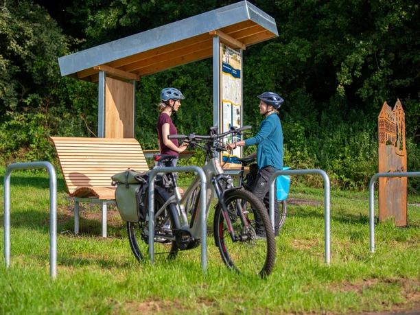 rastplatz_tonenburg_Henning_Orendt (2).jpg Pärchen an einem Fahrradrastplatz mit Holzunterstand, Fahrradanlehnbügeln mit einem Fahrrad, Sitzmöglichkeit