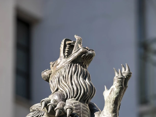 Lion Fountain A majestic, upright lion holds a stone tablet and gazes proudly into the distance.