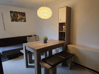 Dining area with high table and four chairs and sofa