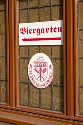 Brewery Schreckenskammer A window of the "Brauhaus Schreckenskammer" brewery in Cologne with a sign pointing towards the beer garden.