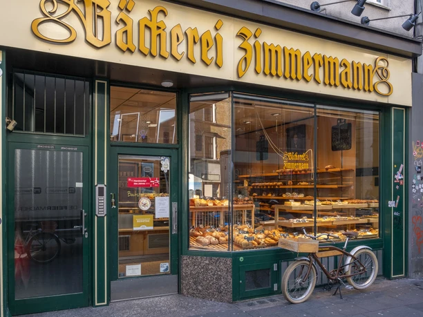 Bakery Zimmermann Exterior view of the bakery. Baked goods are in the shop window and a bicycle is in front of it.