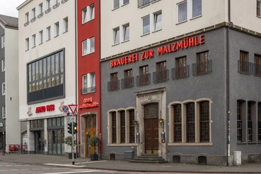 Brewery 'Zur Malzmühle' Modern gray building with neo-inscription “Brauerei zur Malzmühle”.