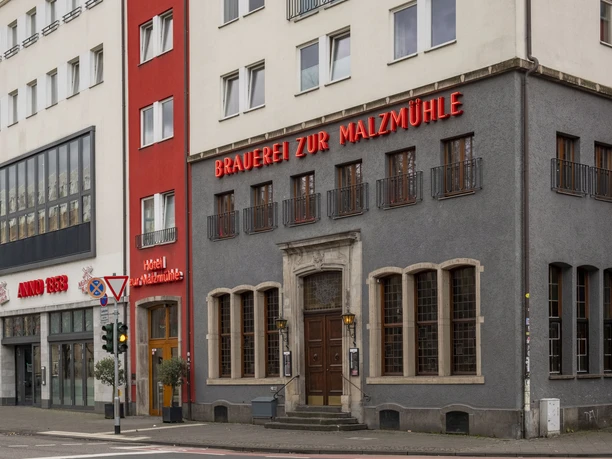 Brewery 'Zur Malzmühle' Modern gray building with neo-inscription “Brauerei zur Malzmühle”.
