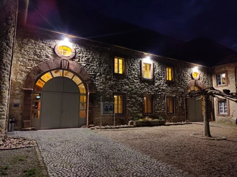 KuStall Ottbergen Abend.jpg Beleuchtete Fassade des Kustalls bei Dunkelheit