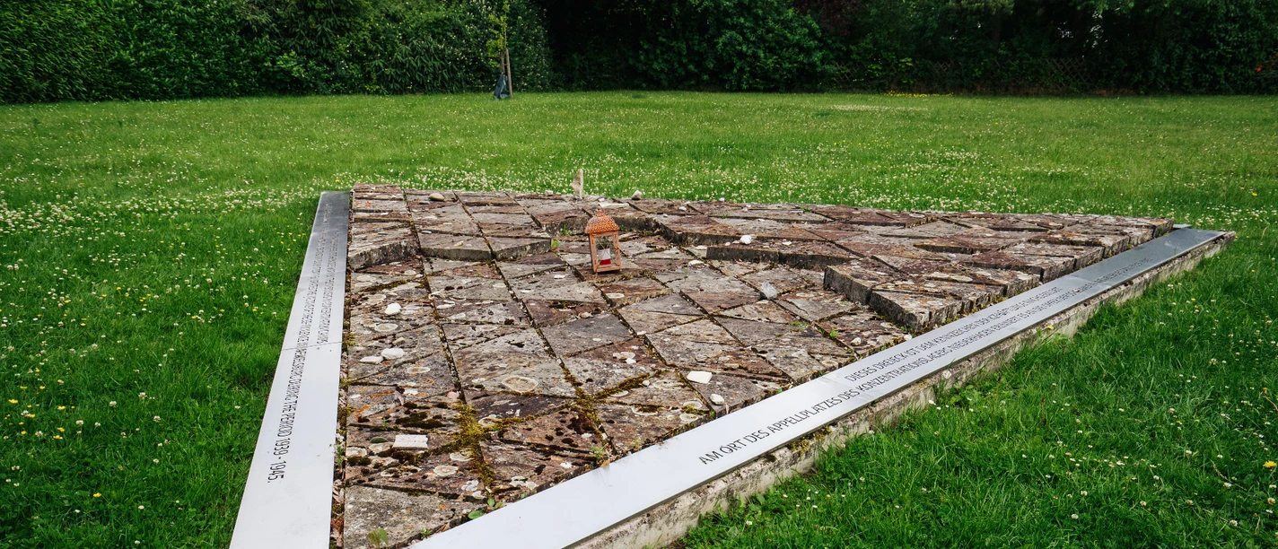 Mahnmal ehemaliges KZ Niederhagen Dreieckiges Mahnmal aus Steinplatten auf Rasen des ehemaligen KZ Niederhagen symbolisiert das Gedenken.