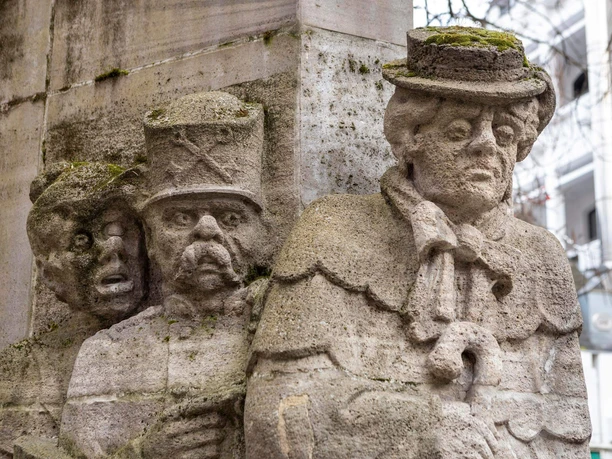 Ostermann Fountain Stone figures at the Ostermann Fountain in Cologne show people in historical costumes with detailed faces.