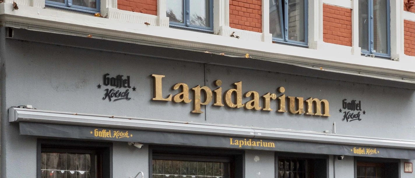 Lapidarium Facade of a historic pub named "Lapidarium" with outdoor seating and brick architecture.