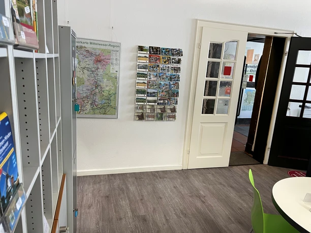 A bright, inviting room in the Nienburg Tourist Information Office, with shelves full of brochures and maps.