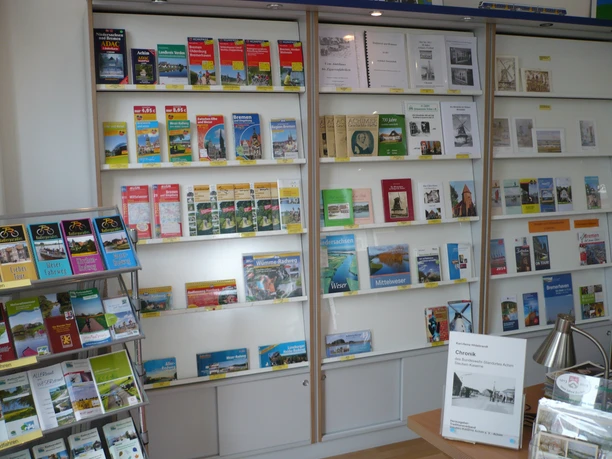 A wide range of brochures and flyers in a bright room with a desk and lamp.