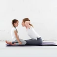 mother with child practicing yoga in lotus pose mother with child practicing yoga in lotus pose