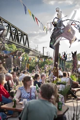 Odonischer Biergarten Menschen genießen geselliges Beisammensein im lebhaften Odonischer Biergarten unter bunten Wimpeln.