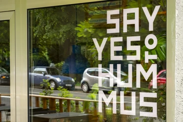 Mashery Hummus Kitchen Eine elegante Fensterfront von Mashery Hummus Kitchen zeigt den Schriftzug "Say Yes to Hummus".