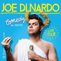 Joe Dinardo in einer humorvollen Pose vor blauem Hintergrund, gekrönt mit goldenen Lorbeeren.
