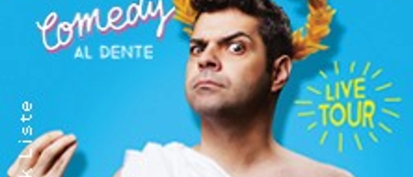 Joe Dinardo in einer humorvollen Pose vor blauem Hintergrund, gekrönt mit goldenen Lorbeeren.