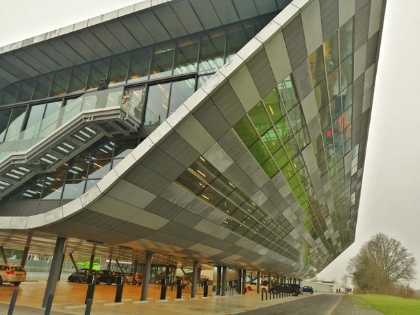 Herford-Bora Flagshipstore_Pro Herford GmbH (2).jpeg Moderne Architektur des Herford-Bora Flagshipstore mit Glasfassade und asymmetrischem Design.