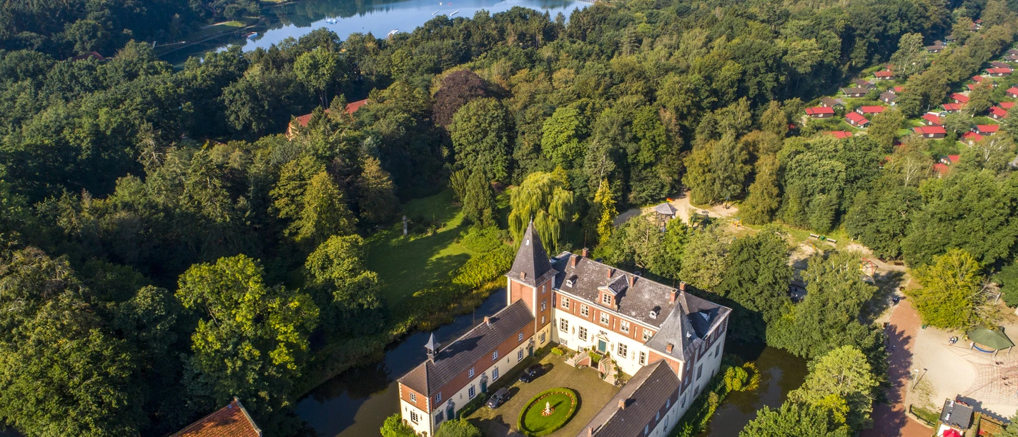 Das Emsland von oben – Ferienzentrum Schloss Dankern in Haren (Ems) ©Emsland Tourismus GmbH (3).jpg Luftaufnahme des Ferienzentrums Schloss Dankern mit dem See, Waldfläche und roten Ferienhäusern.