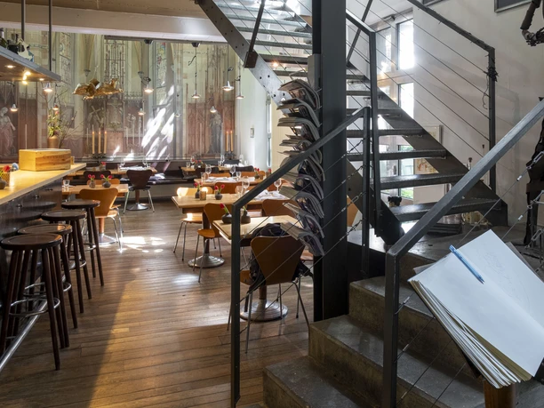 Christoph Pauls Restaurant Interior view of an elegant restaurant with stylish wooden furniture and modern decoration.