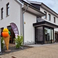 Außenansicht Bäckerei-Cafe Schultze Mühlenfeld Einladendes Eiscafé mit modernen Sitzmöglichkeiten und bunter Eisdeko im Vordergrund.