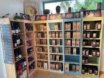 The picture shows a sales area with colorful shelves filled with wine bottles and coffee products.