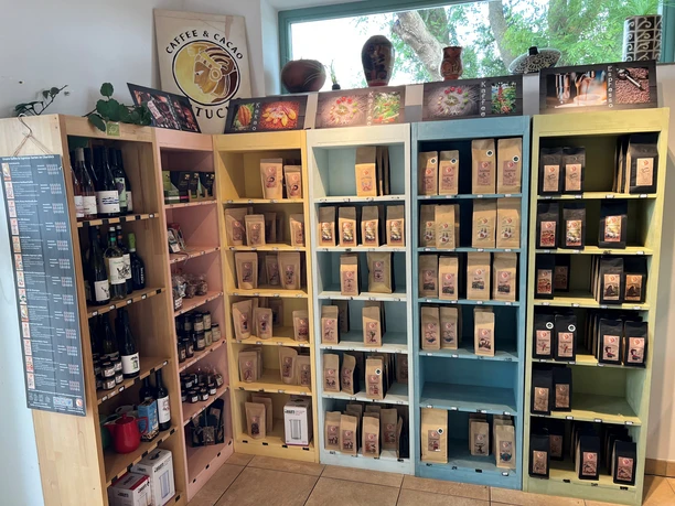 The picture shows a sales area with colorful shelves filled with wine bottles and coffee products.