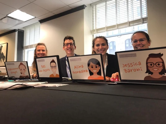 Time Change GmbH The Time Change GmbH team sits smiling at the registration counter.