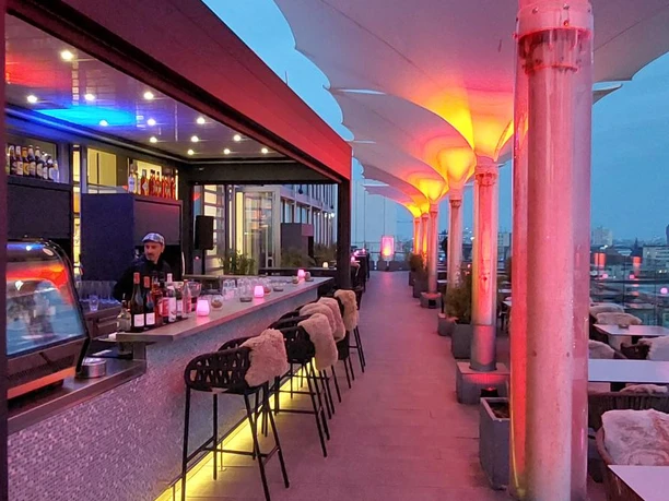 Rooftop bar at night with atmospheric lighting