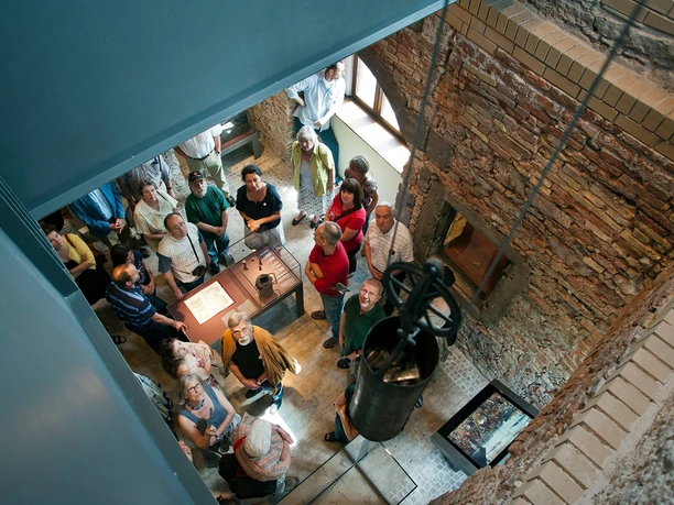 Group of visitors in Rententurm looking up through open clock shaft