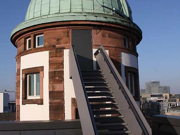 Historic observatory with green dome and rooftop access